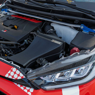 GR Yaris engine bay with open hood, shows PIRAS Motorsport Airbox installed, 45 degree front left view